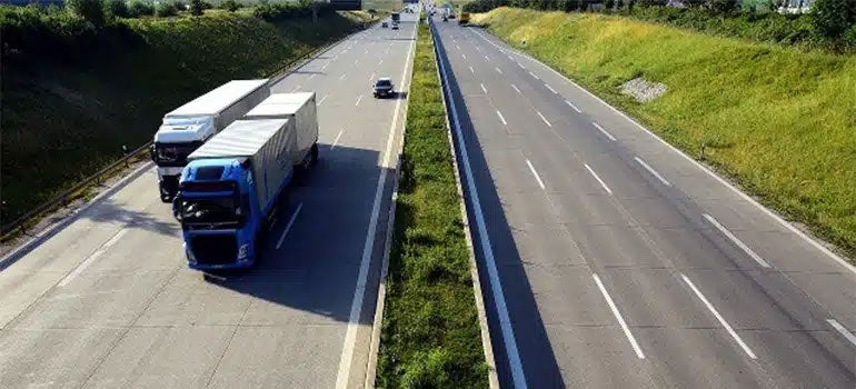 Trucks going down highway in New York 