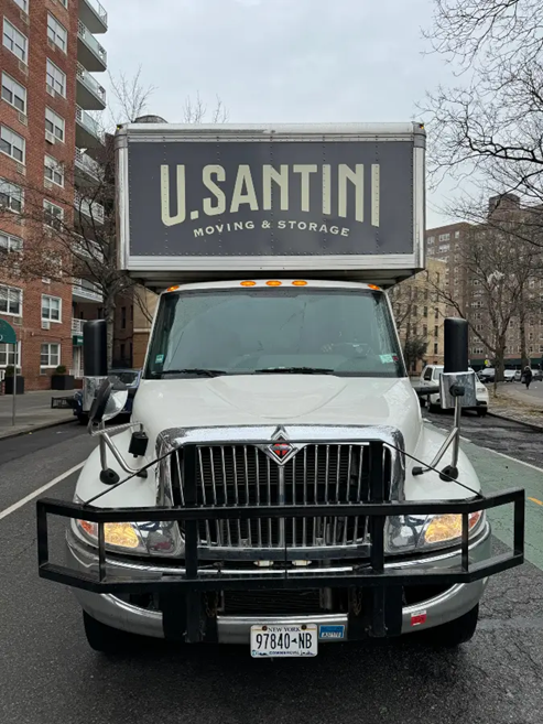 A moving truck carrying boxes across New York City