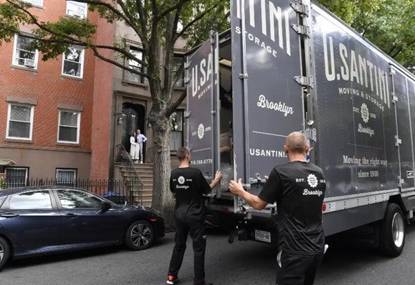 U.Santini professionals closing truck doors in Brooklyn, New York
