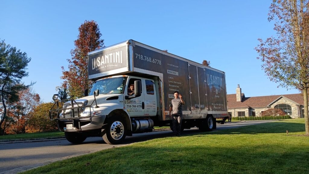 Two U.Santini workers with a truck at a New York home 