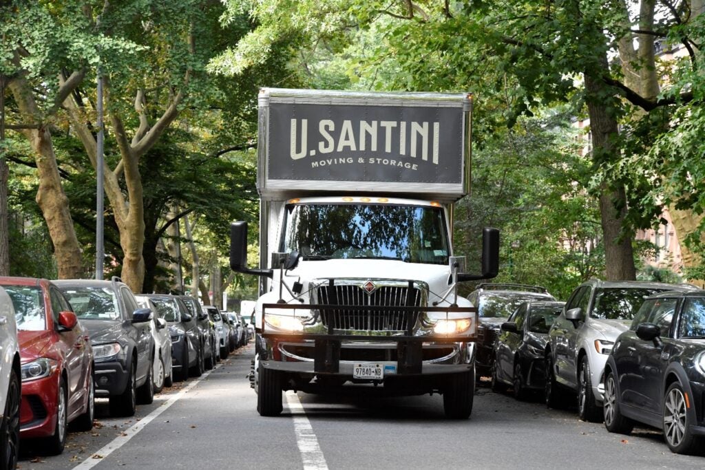 U.Santini moving truck going down a New York street