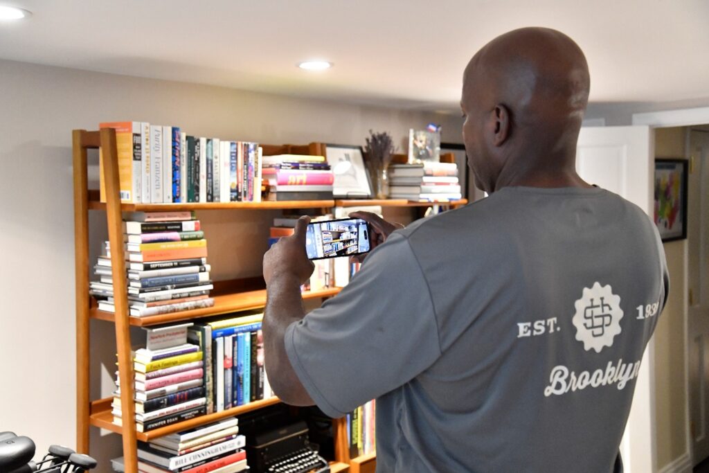 U.Santini worker taking a picture of a book shelf