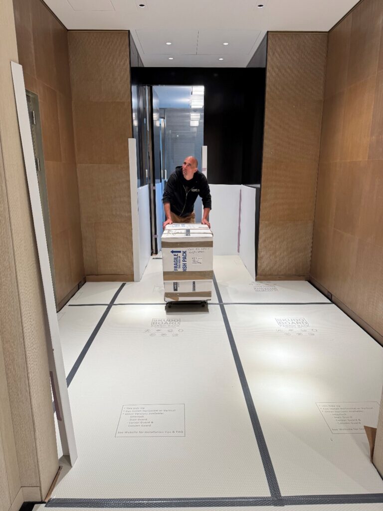 A person standing in a hallway in a minimalist New York home