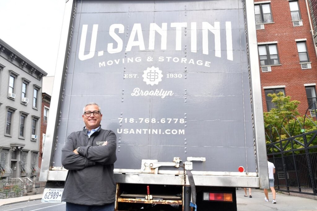 A person standing in front of a truck