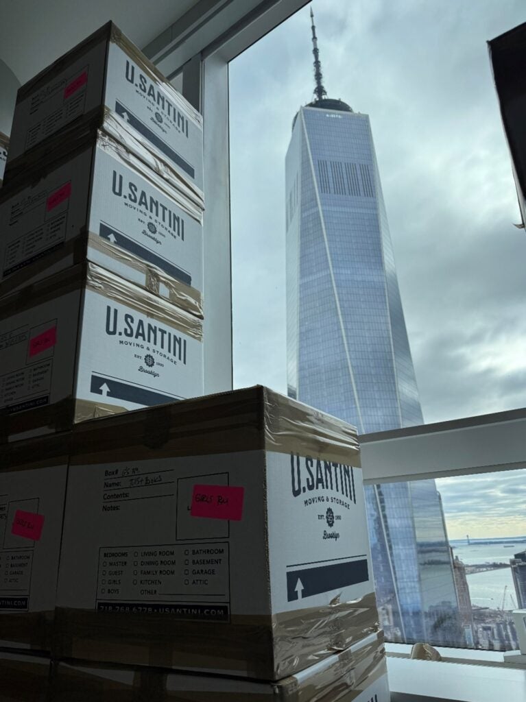 A stack of boxes in front of a tall building