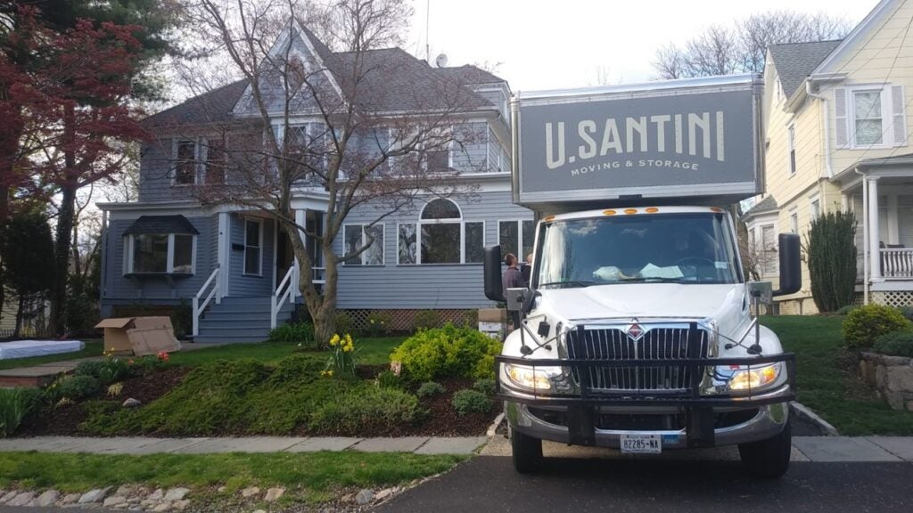 A truck parked in front of a house in New York
