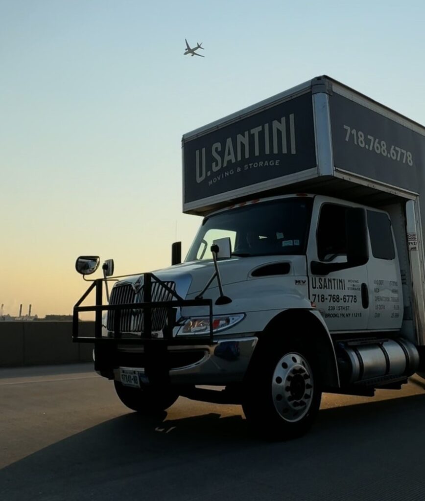 A truck with a plane in the background