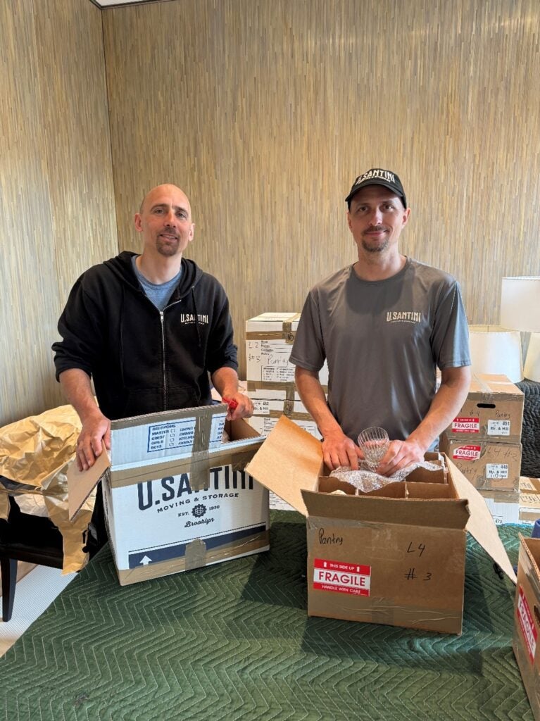 Two U.Santini workers packing boxes