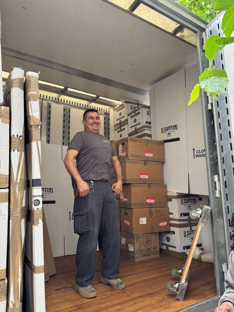 U.Santini worker flexes in moving truck